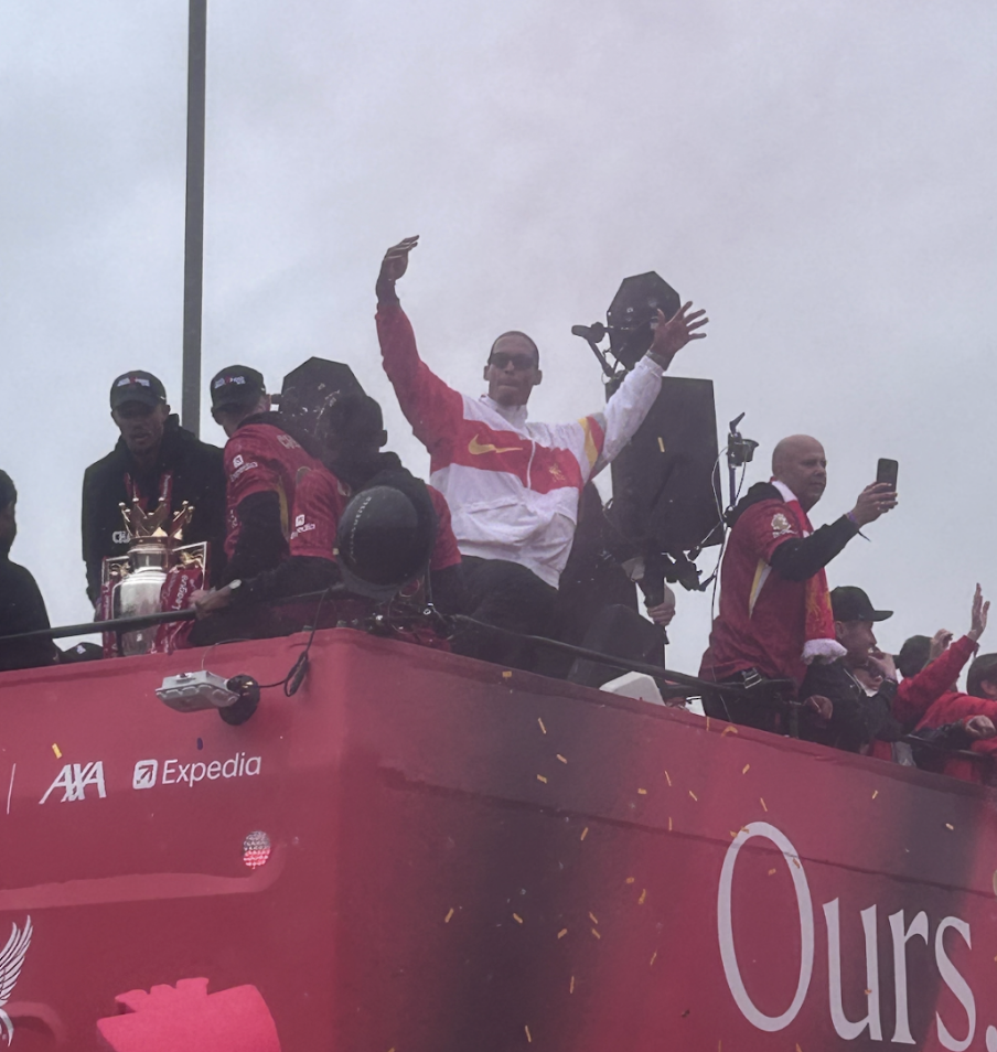 Virgil Van Dyke on the Liverpool open bus with Premier League trophy with his fellow players and manager